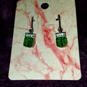 Earrings with emerald colored stones.